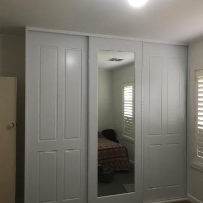 Three door robe with Stanford doors and inlaid mirror 